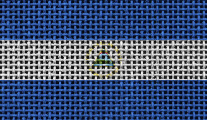 Nicaragua flag on the surface of a metal lattice. 3D image