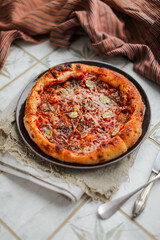 Very appetizing pizza with parmesan cheese, tomato sauce and garlic. Italian cuisine. Round savory pastry.