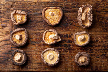 Dried shiitake mushrooms on a wooden background top view