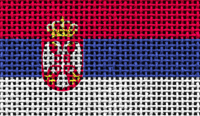 Serbia flag on the surface of a metal lattice. 3D image