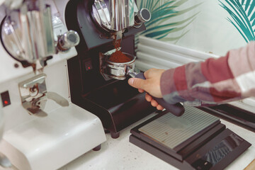 Process of pouring ground coffee into the filter
