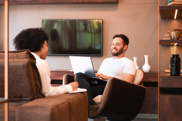 happy college student studying with friend and laptop in living room