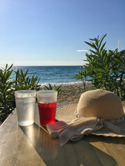 relax on the beach with drinks and sun hat