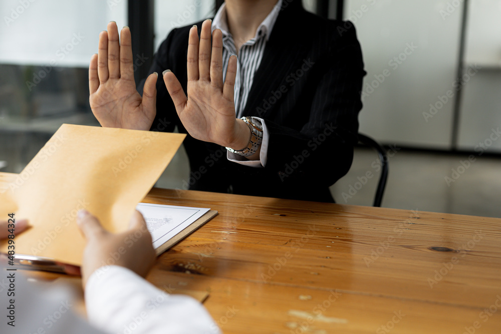 Wall mural business man raised her hand to deny accepting a bribe from a business partner, a brown envelope con