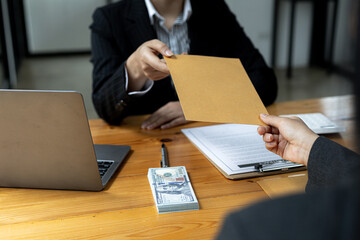 Two businessmen are handing out envelopes, two businessmen are working together to corrupt the...