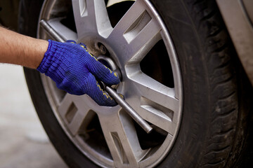 Proffesional change of tires on the car with tools. Safety concept. High quality photo