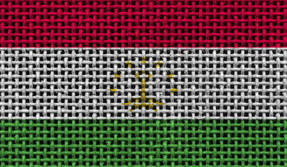 Tajikistan flag on the surface of a metal lattice. 3D image