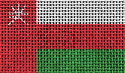 Oman flag on the surface of a metal lattice. 3D image