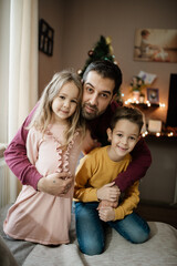 Father and children looking at camera.