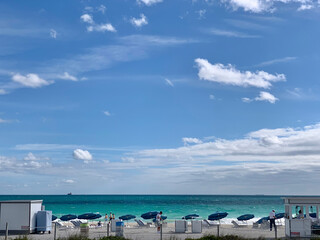 Blue Beach Umbrellas and People on Cloudy Day, Miami Beach, FL, US
