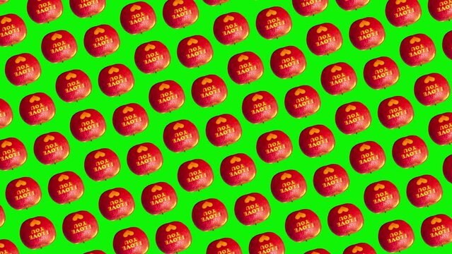 alentine's Day themed pattern apples with I Love You message and a heart symbol animated on a isolated background. advertising concept /High quality 4k sweets footage. Minimal motion design graphics a