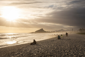 Fototapeta na wymiar Beautiful view to people watching the sunset from Itauna Beach