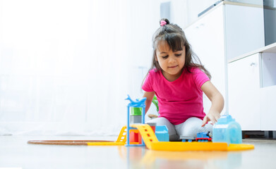 baby game. Little clever caucasian child playing colorful toy railway and train for early development.