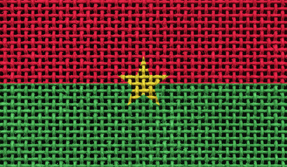 Burkina Faso flag on the surface of a metal lattice. 3D image