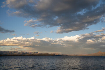 Magical view of Nahuel Huapi lake at sunset. Beautiful clouds and dusk colors in the sky. 
