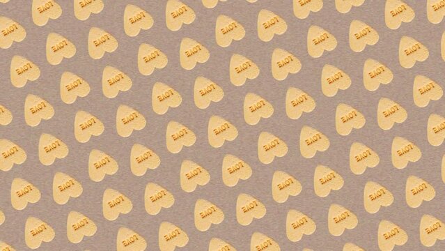 Colorful pattern of circular rotating Sweet hearts shaped yellow Sugar Pill Candy isolated on Noise paper texture background. 3 in 1 different sides and size animations for 10 sec. Love 4K Creative an