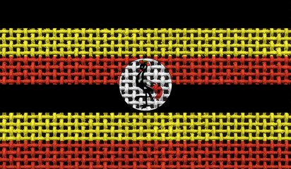 Uganda flag on the surface of a metal lattice. 3D image