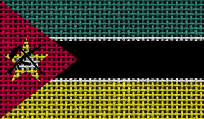 Mozambique flag on the surface of a metal lattice. 3D image