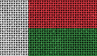 Madagascar flag on the surface of a metal lattice. 3D image