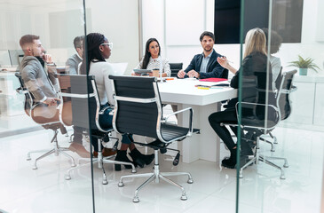 Business people discussing together in conference room during meeting at office in a modern startup.