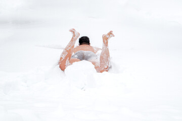 a large man bathes in the snow after a hot bath