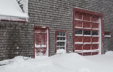 barn Red doors in winter snow storm