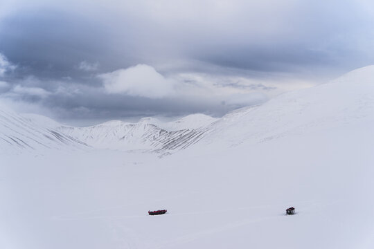 Two expedition sleighs are left in the snow