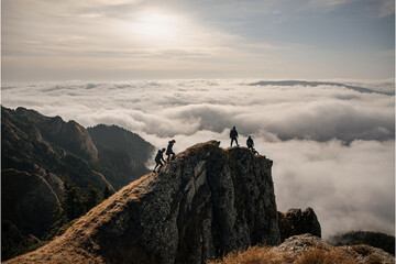 Young people enjoying the view above clouds on the mountain
