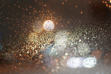 Blurred background with raindrops and lights.