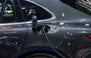 Obraz na płótnie Canvas Electric car charging plug in the city.