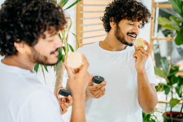 Haircare, eco friendly zero waste concept. latin beard man with dreamy expression on face sniffing...