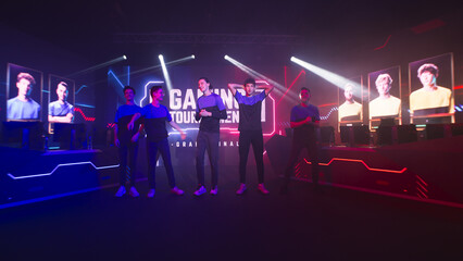 Young men walking together then gesticulating and greeting audience at start of gaming tournament © Framestock