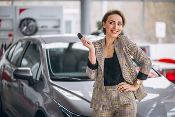 Woman with keys by the car