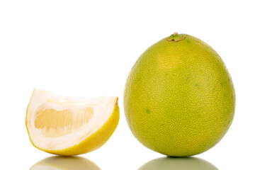 Fototapeta premium One slice and one whole sweet pomelo, macro, isolated on white.
