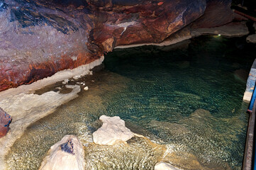 Stalactite, stalagmite on the walls of the cave. Cave lake. Template for design.