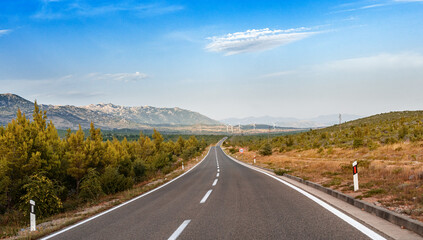Fototapeta premium Scenic road. The road is surrounded by a magnificent natural landscape.