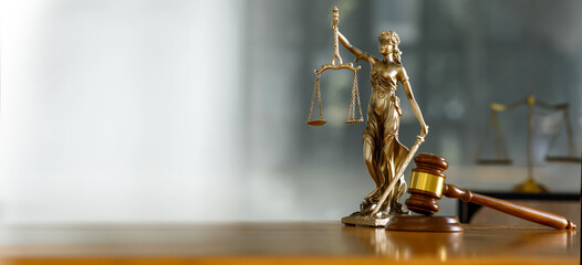 Legal and law. Statue of Lady Justice with scales of justice and wooden judge gavel on wooden...