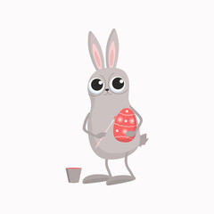 The Easter Bunny is painting an egg. Cartoon rabbit with brush, paint and egg. Easter holiday traditional attributes. Vector illustration with isolated background.