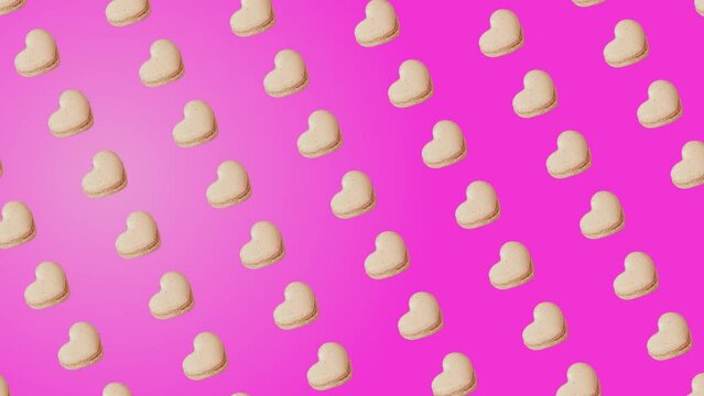 Professional motion design 4K animated pattern with vanilla French Macaroons cookies in heart shape Moving puls on different sides on trending pink color gradient background