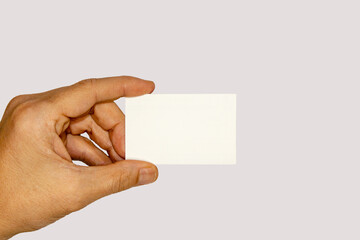 Fototapeta premium A male hand holding blank business card