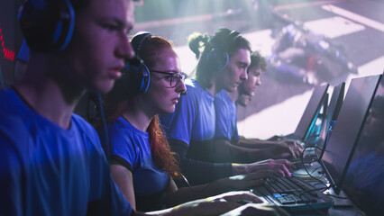 Team of male and female esportsman gamers playing shooter on computers during professional gaming tournament battle © Framestock