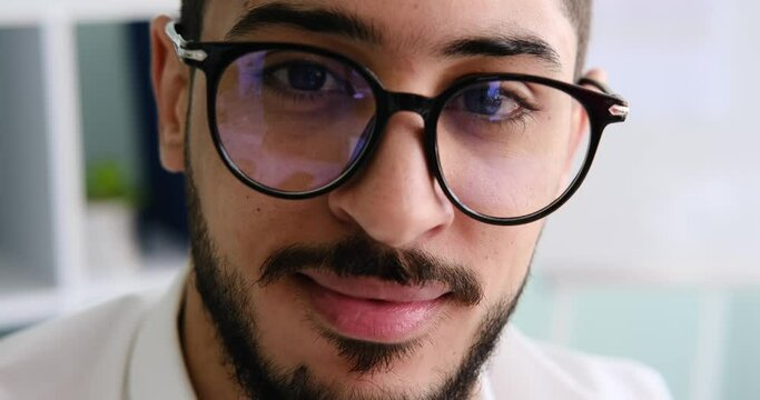 Face of confident businessman in eyeglasses at office