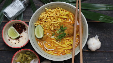 Khao Soi Recipe,Khao Soi,Khao Soi Kai, Thai Noodles Khao Soi, Chicken Curry with seasoning served on wooden table