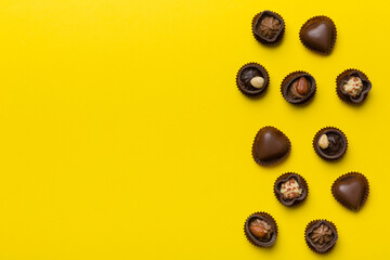 Different kinds of chocolates on colored table close-up. Top View and Flat Lay with copy space