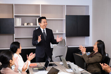 Group of business person applause  and feeling happy for their success from online distance meeting in front of computer laptop. New normal for business and working.