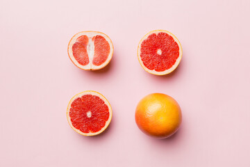 fresh Fruit grapefruit with Juicy grapefruit slices on colored background. Top view. Copy Space. creative summer concept. Half of citrus in minimal flat lay with copy space