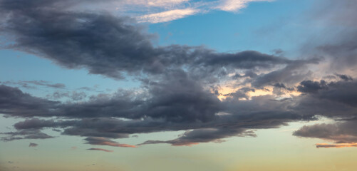 Twilight light color the cloudy sky. Cloud on blue sky background. Cloudscape grey and orange shade.