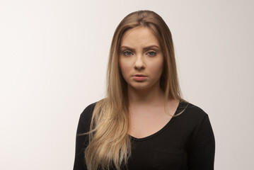 Portrait of sad young woman emotional alone in white background