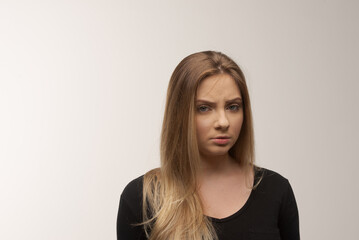 Portrait of sad young woman emotional alone in white background