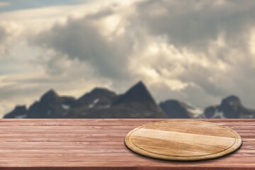 Empty wooden table with Mountain soft blurry background. Use as products display montage.